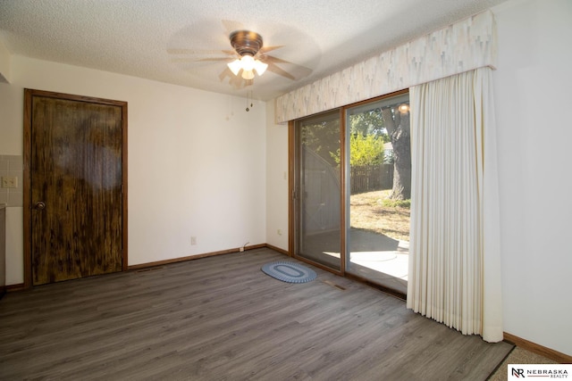 unfurnished room with baseboards, a textured ceiling, ceiling fan, and wood finished floors