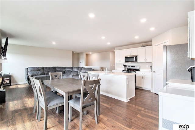 dining room featuring dark wood finished floors and recessed lighting