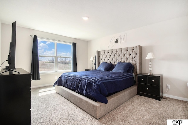 bedroom featuring baseboards and light carpet
