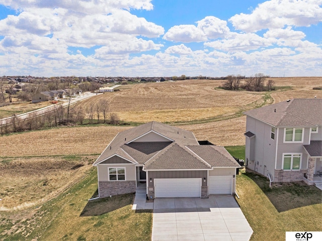 birds eye view of property featuring a rural view