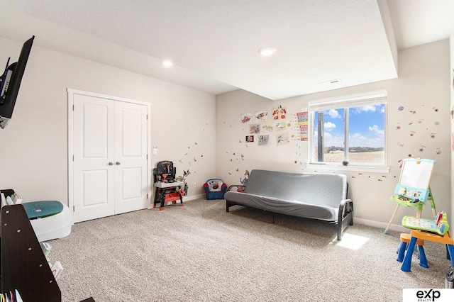 carpeted bedroom with a closet, baseboards, recessed lighting, and visible vents