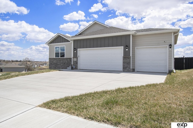 view of front of home with a shingled roof, an attached garage, stone siding, board and batten siding, and driveway