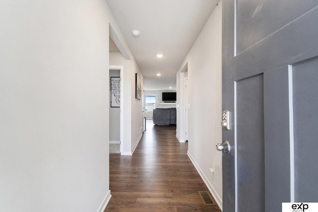 hallway featuring baseboards, dark wood-style floors, visible vents, and recessed lighting