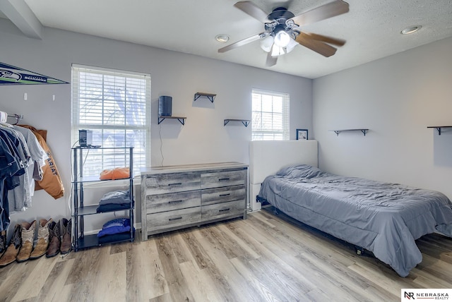 bedroom featuring light wood-style floors and ceiling fan