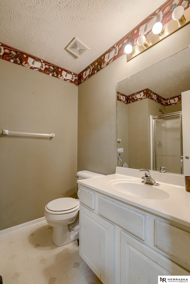 bathroom with visible vents, toilet, a textured ceiling, a shower stall, and vanity