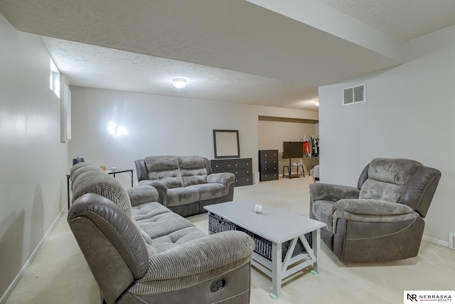 living area featuring visible vents, light carpet, a textured ceiling, and baseboards