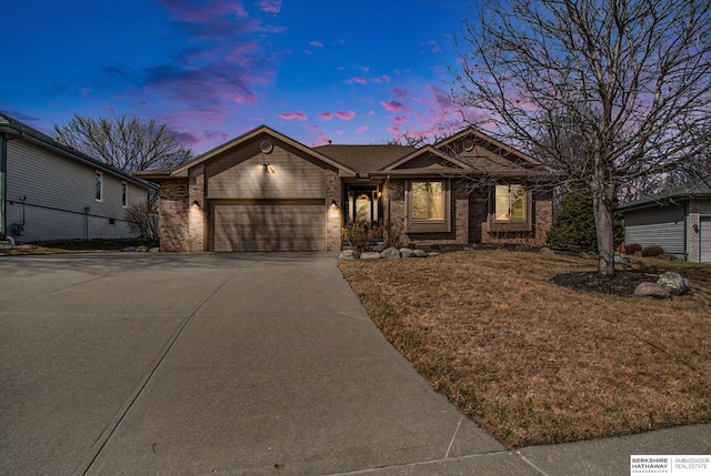 ranch-style house featuring brick siding, a garage, and driveway