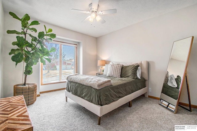 bedroom featuring baseboards, a textured ceiling, ceiling fan, and carpet flooring