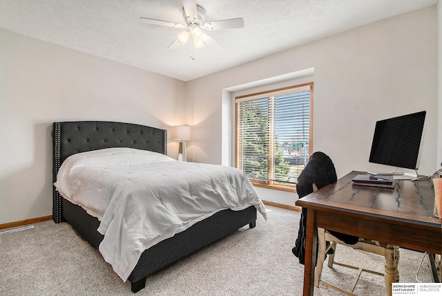 bedroom with baseboards, carpet floors, a textured ceiling, and a ceiling fan