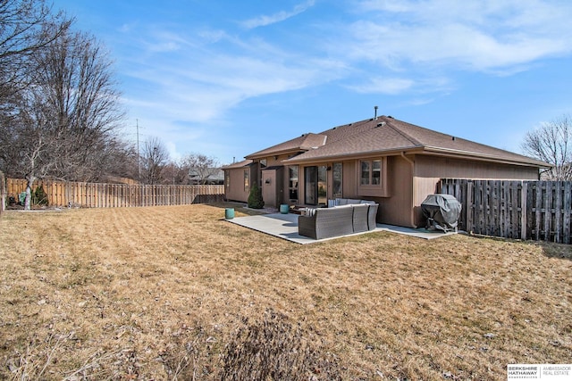 back of house featuring a yard, a fenced backyard, a shingled roof, outdoor lounge area, and a patio area