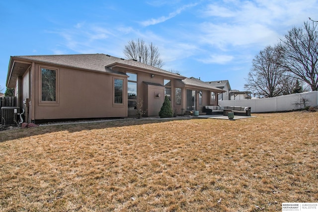 rear view of house featuring a patio, fence, a yard, central air condition unit, and an outdoor hangout area