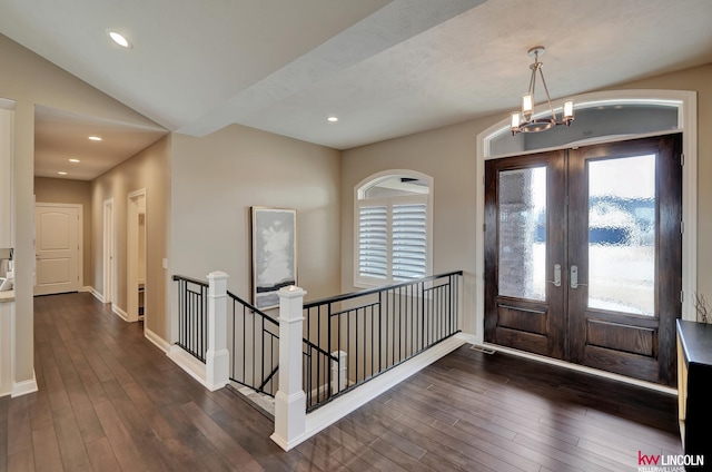 foyer entrance with baseboards, dark wood finished floors, a chandelier, recessed lighting, and french doors