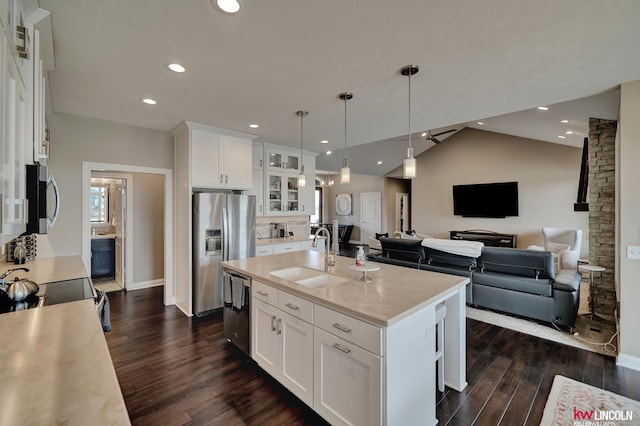 kitchen featuring dark wood finished floors, light countertops, white cabinets, stainless steel appliances, and a sink