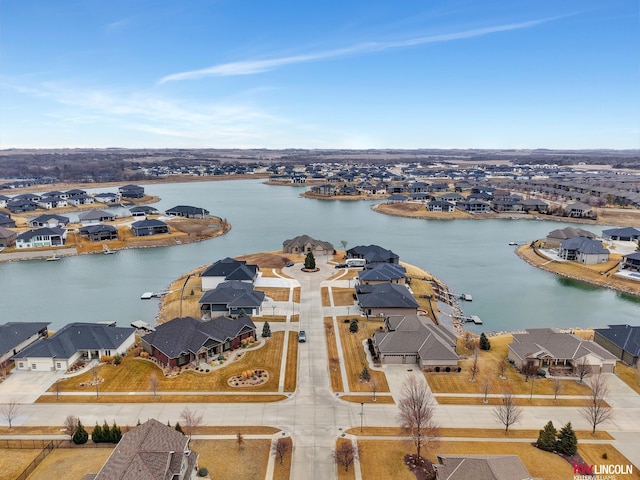 drone / aerial view featuring a residential view and a water view