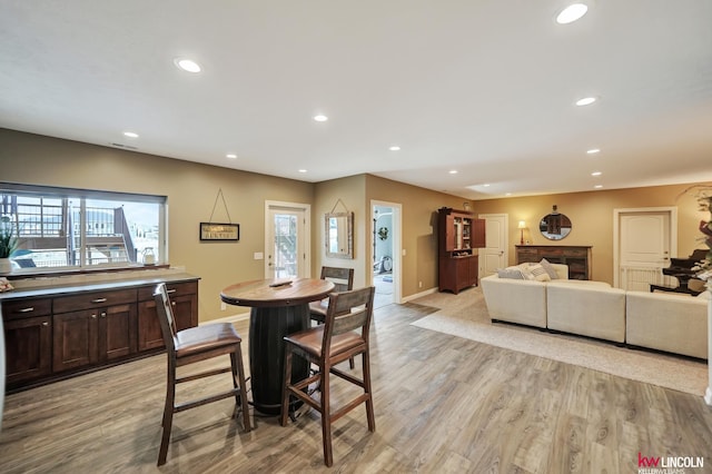 dining area with recessed lighting, light wood-type flooring, and baseboards