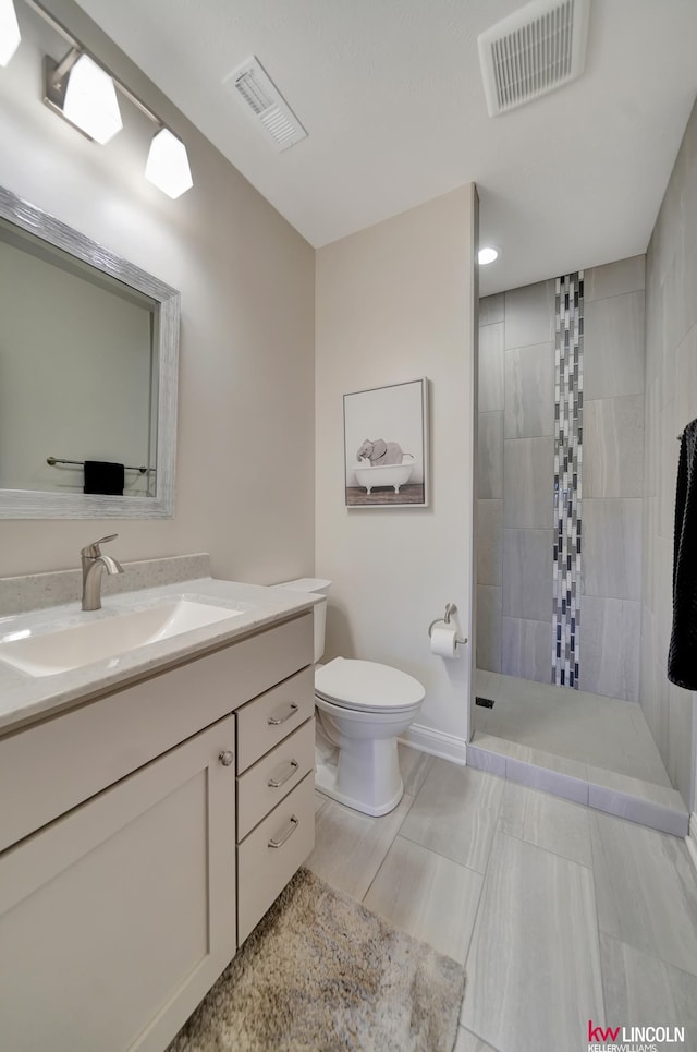 full bath featuring visible vents, toilet, vanity, and walk in shower