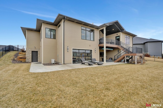 rear view of house featuring fence, stairway, cooling unit, a yard, and a patio area