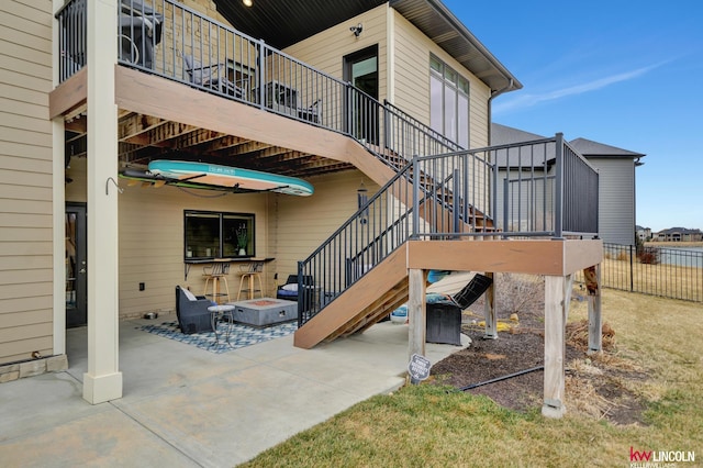 view of patio featuring a fire pit, stairs, and fence