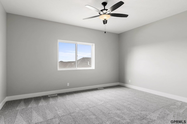 unfurnished room with baseboards, visible vents, carpet, and a ceiling fan