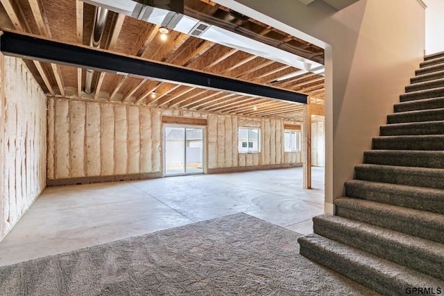 interior space with concrete flooring and stairs