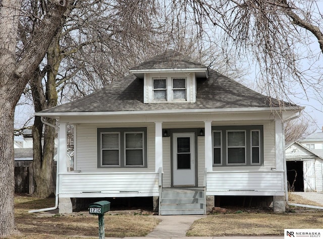 bungalow-style house featuring a porch and a shingled roof