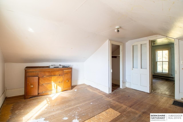 bonus room with baseboards, wood-type flooring, and lofted ceiling