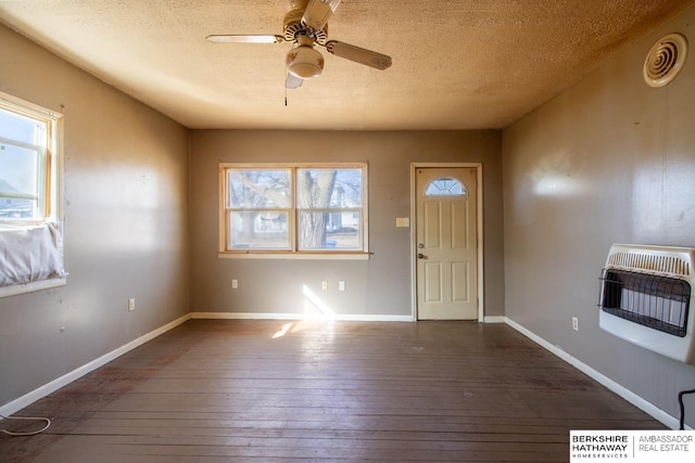 foyer featuring visible vents, ceiling fan, baseboards, hardwood / wood-style flooring, and heating unit