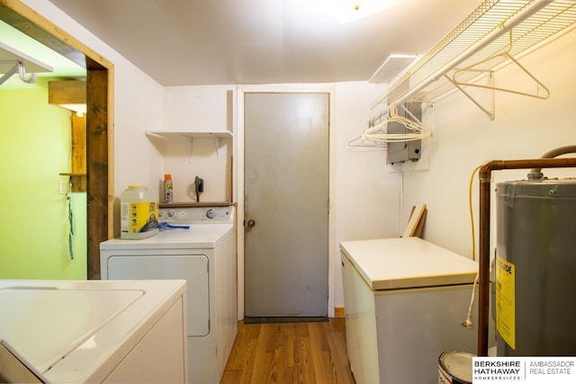 laundry area with water heater, light wood-style flooring, laundry area, and washer and clothes dryer