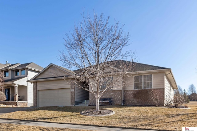 single story home featuring a front yard, brick siding, concrete driveway, and an attached garage