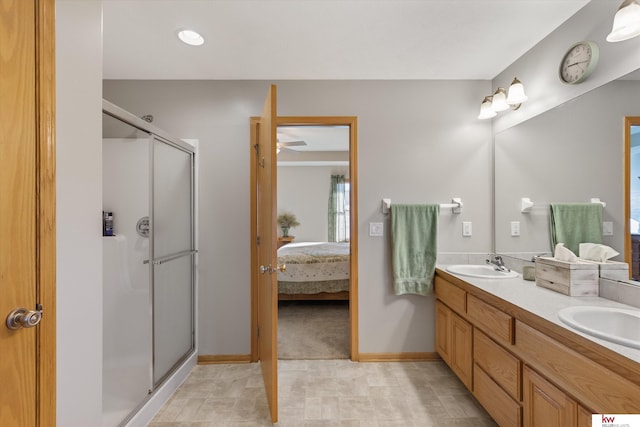 full bath featuring a sink, a shower stall, ensuite bathroom, and double vanity