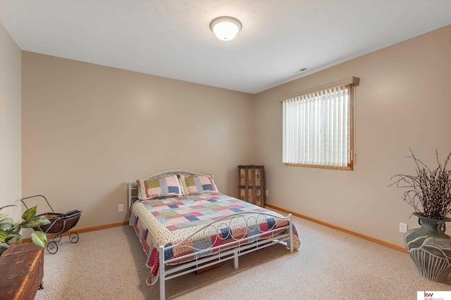 carpeted bedroom featuring visible vents and baseboards