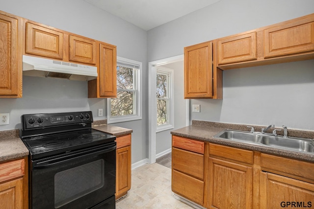 kitchen featuring black electric range oven, dark countertops, under cabinet range hood, and a sink