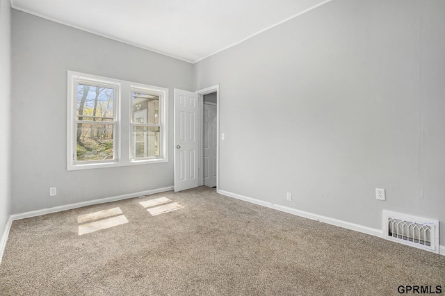 carpeted empty room with visible vents and baseboards