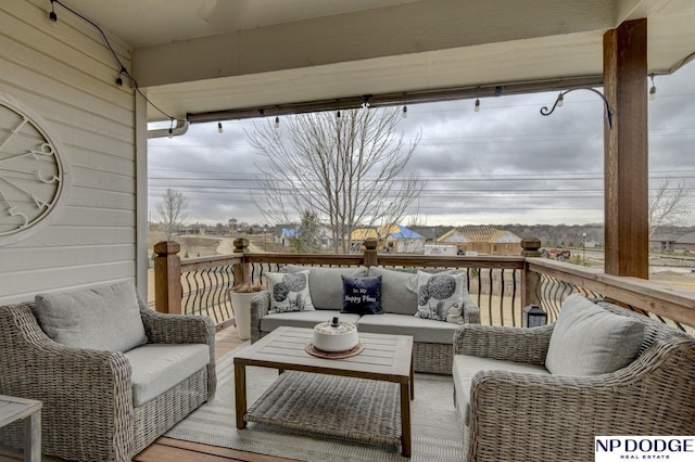 wooden terrace with an outdoor living space