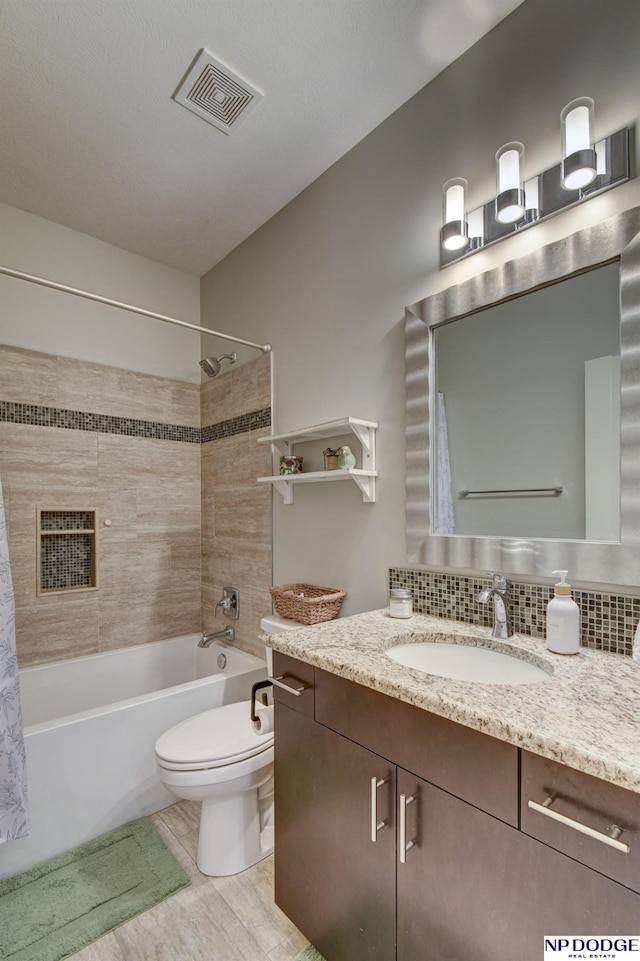 full bathroom with visible vents, toilet, shower / bath combination, decorative backsplash, and vanity