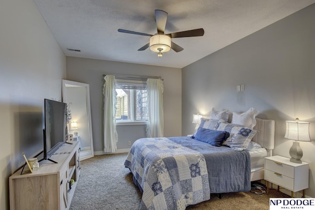 carpeted bedroom with a ceiling fan and baseboards