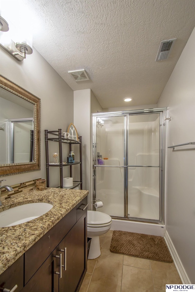 bathroom featuring tile patterned flooring, visible vents, a shower stall, and toilet