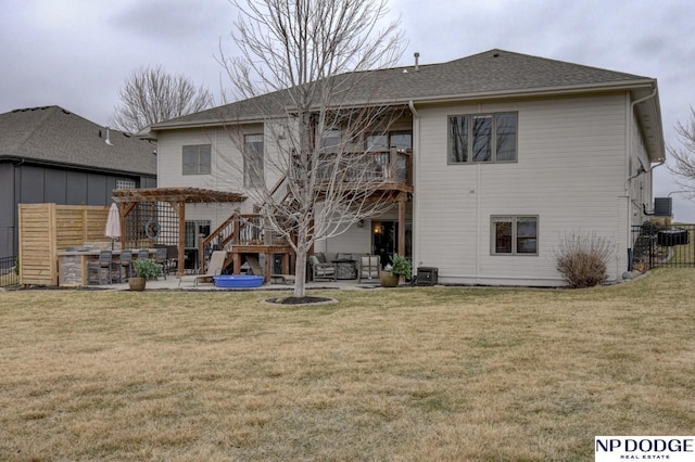 rear view of house featuring a yard, a pergola, a patio, and fence