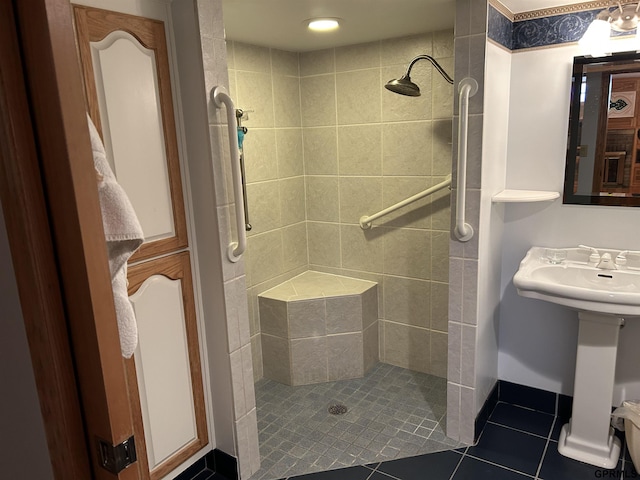 full bathroom featuring tile patterned floors and a tile shower