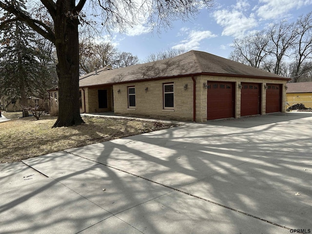 exterior space featuring stone siding, concrete driveway, and a shingled roof