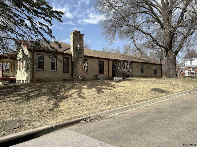 back of property with roof with shingles and a chimney