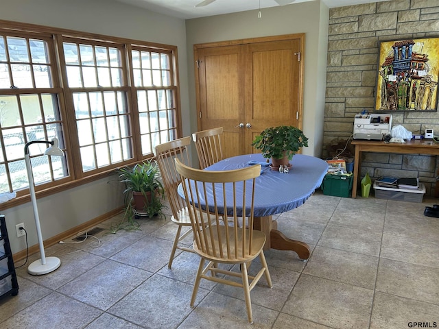 dining area with ceiling fan and baseboards