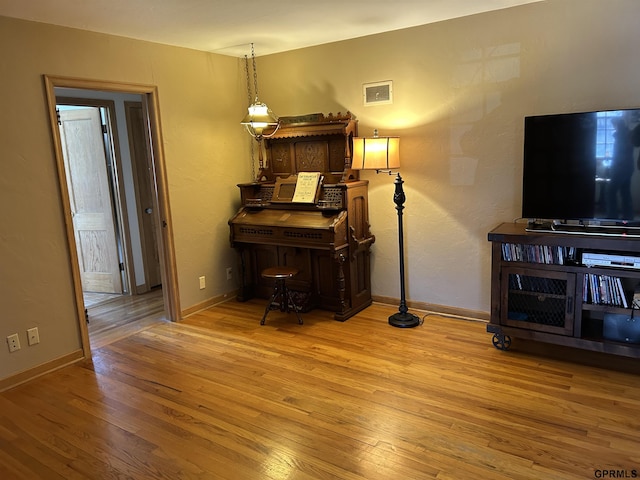 interior space featuring baseboards and wood finished floors