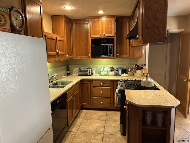 kitchen with open shelves, freestanding refrigerator, a sink, black dishwasher, and gas range oven