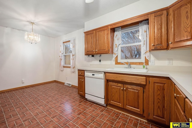 kitchen with a notable chandelier, a sink, white dishwasher, light countertops, and baseboards