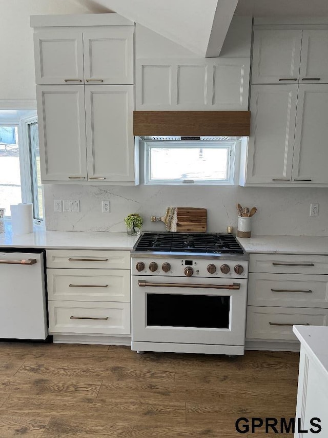 kitchen featuring white appliances, dark wood-type flooring, white cabinets, and light countertops