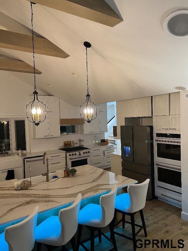 kitchen with high end white range, an inviting chandelier, black fridge with ice dispenser, white cabinetry, and a sink