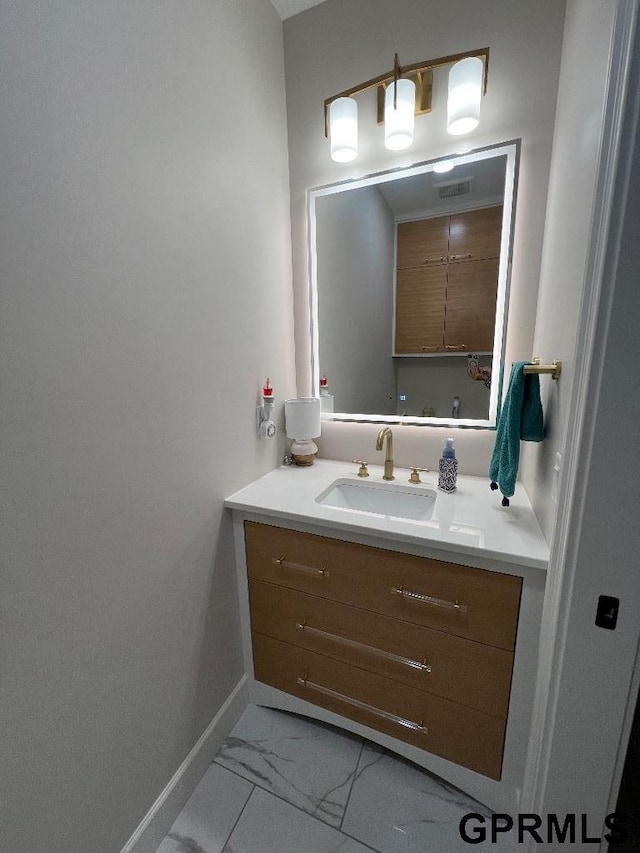 bathroom with visible vents, baseboards, marble finish floor, and vanity