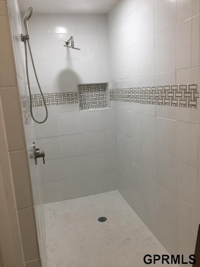 bathroom with a tile shower