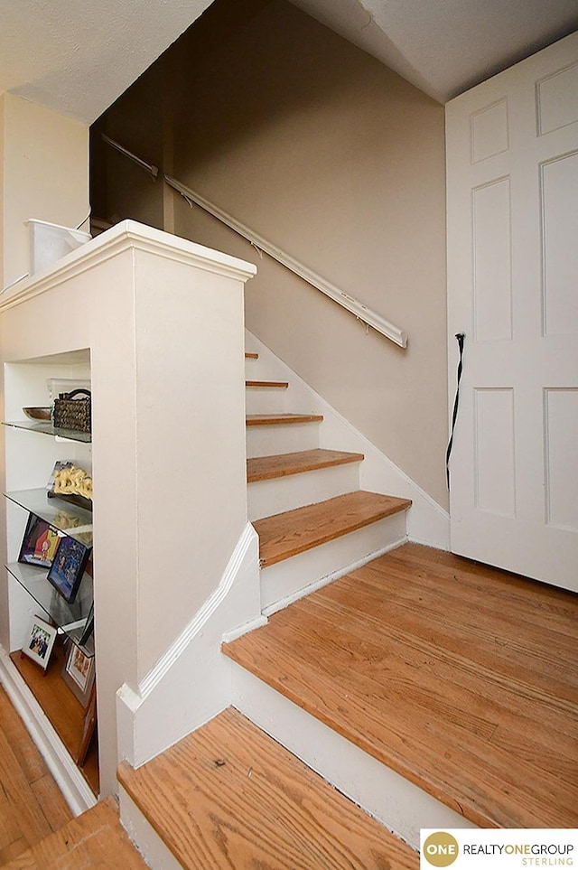 staircase featuring wood finished floors